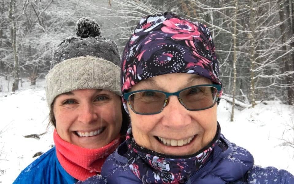 Emily and her mom smiling in the snow.