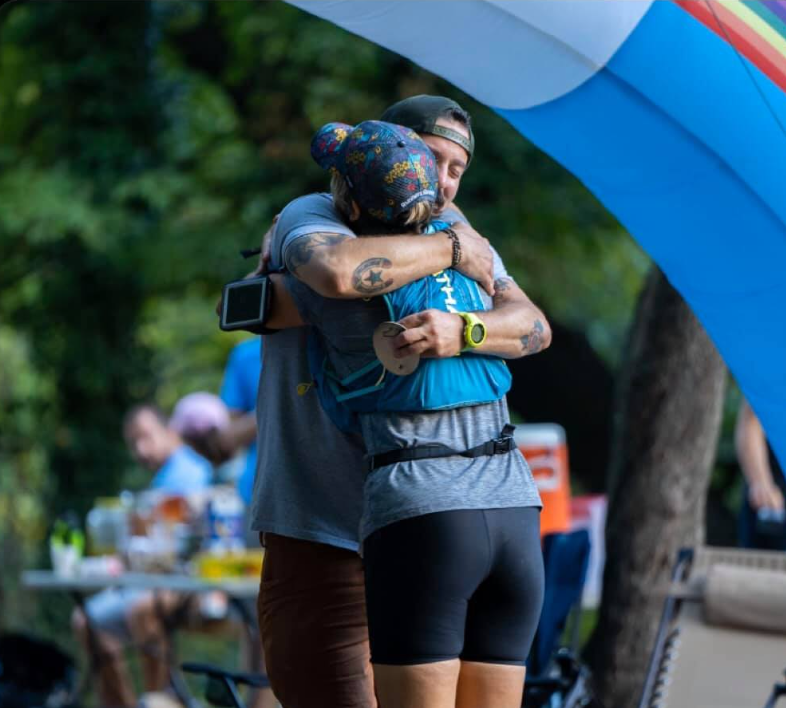 Jason Green hugging a finisher.